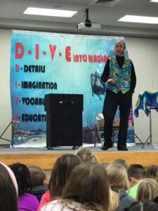 Marty the Magician presents the Dive Into Reading program at an elementary school.