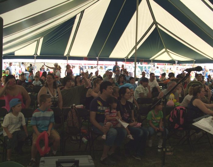 Audience under striped tent