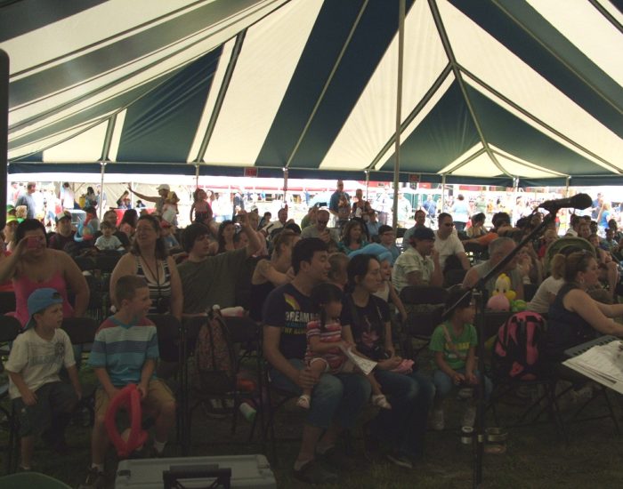 Audience under striped tent